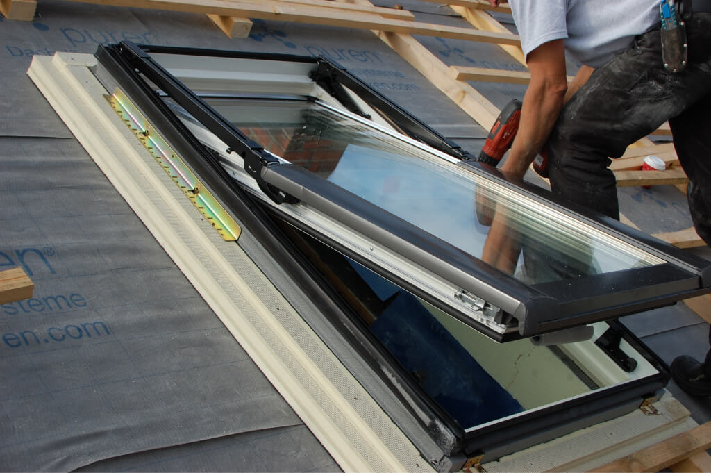 Man assembling a roof window skylight